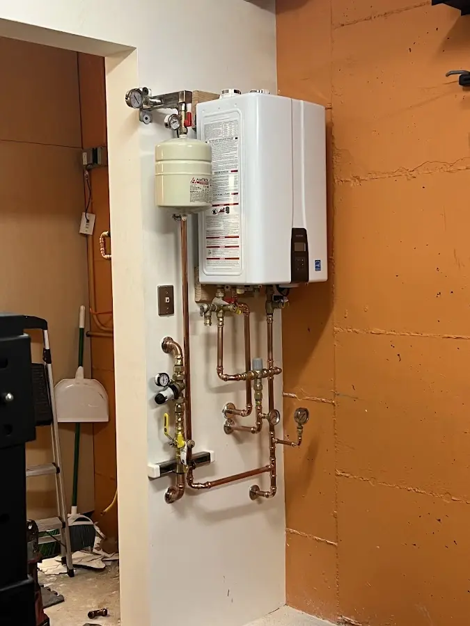 Plumbing technician inspecting water heater connections in Hollywood